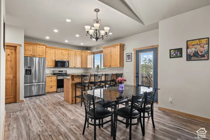 Spacious kitchen featuring wood cabinetry, stainless steel appliances, and wood-finish flooring