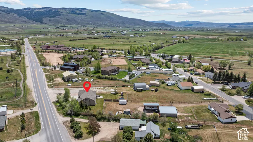 Aerial perspective showcasing a single-family residence with a light-colored roof