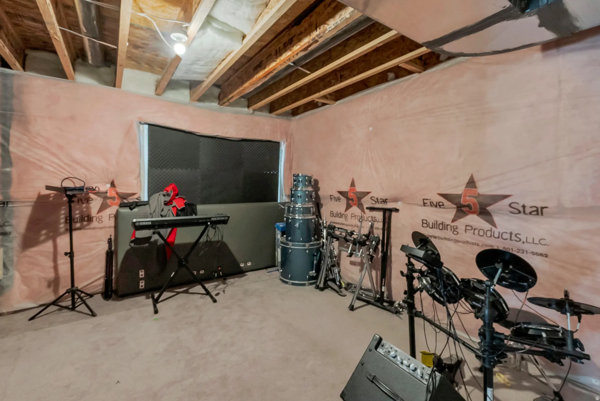 Unfinished basement space featuring exposed ceiling joists and insulation