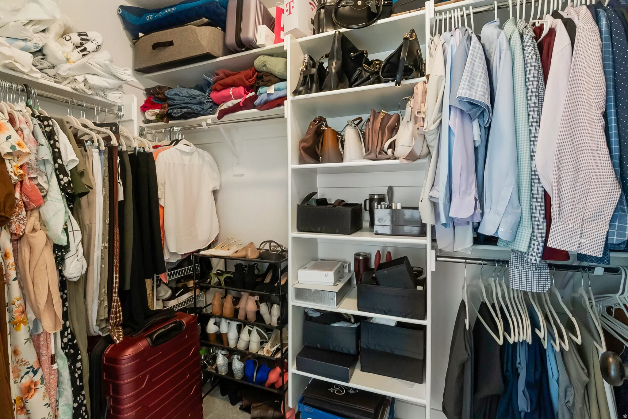 Custom closet system featuring multiple hanging rods, integrated shelving, and dedicated storage compartments