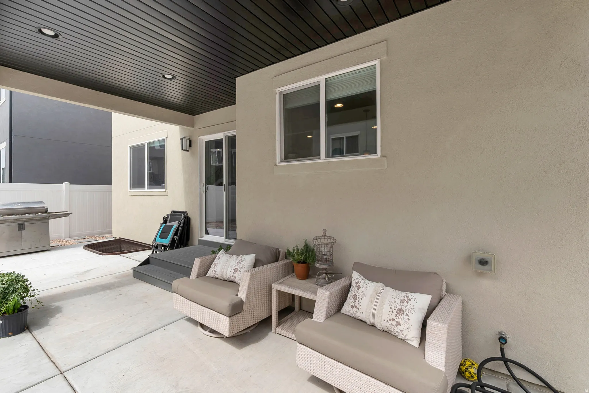 Covered patio featuring recessed lighting, a sliding glass door, and a concrete slab