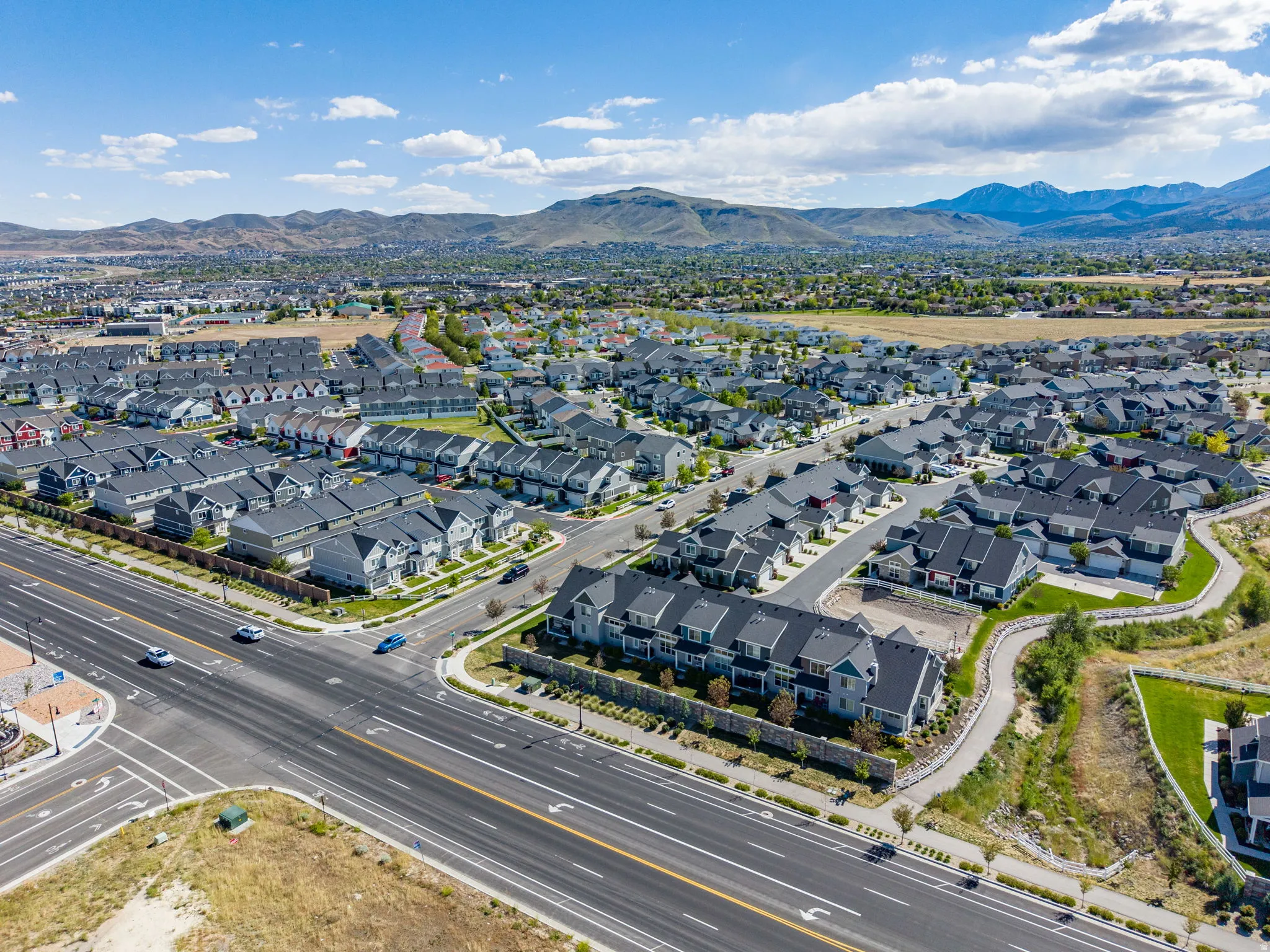 Aerial perspective of a developed residential community featuring diverse architectural styles and extensive paved infrastructure