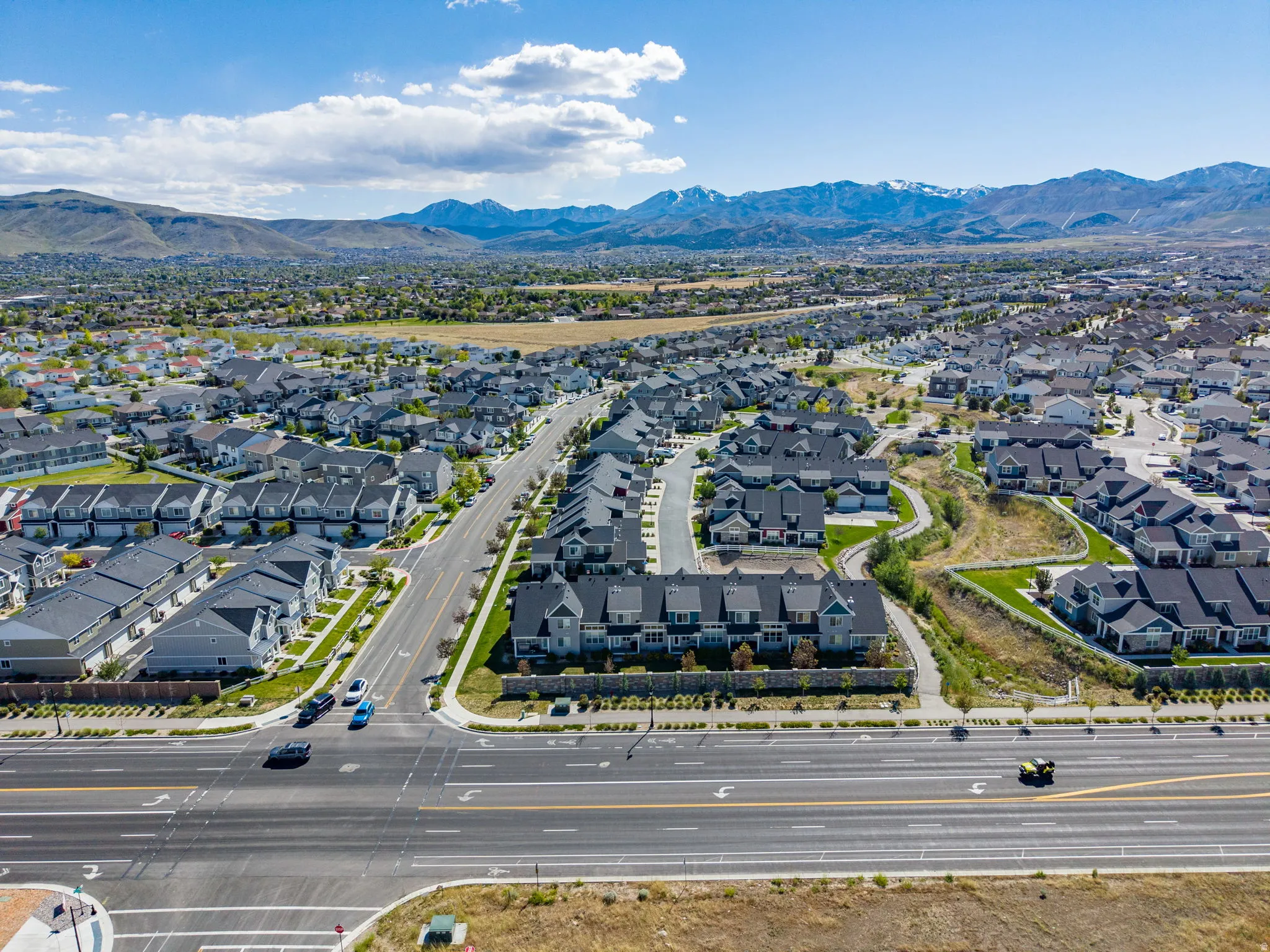 Aerial perspective showcasing a residential community with a mountain backdrop