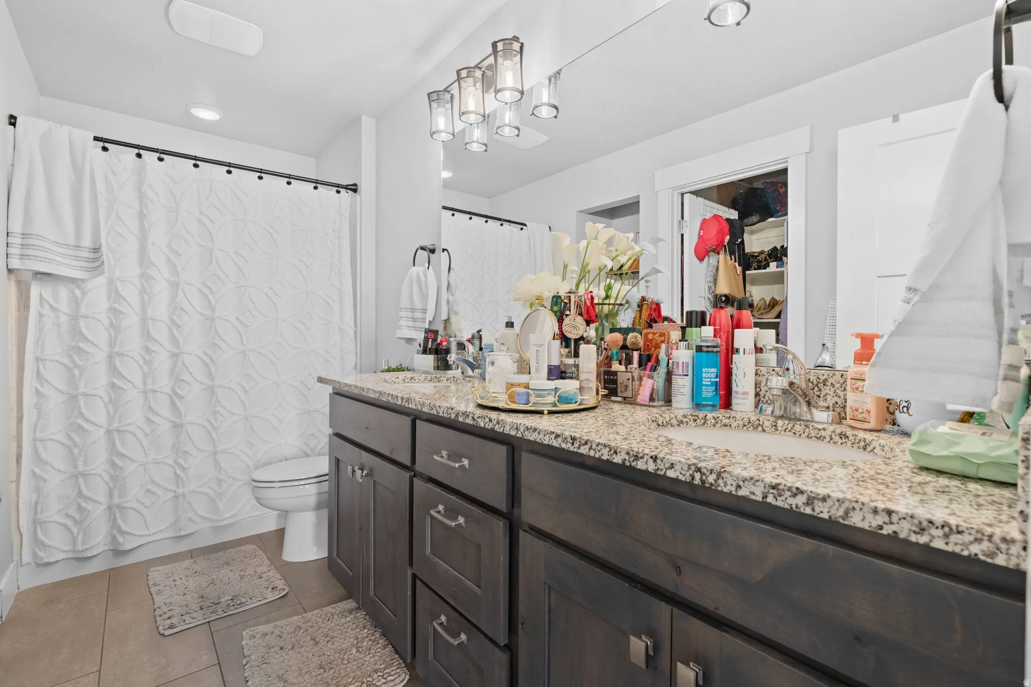 Double vanity with a granite-style countertop and undermount sinks