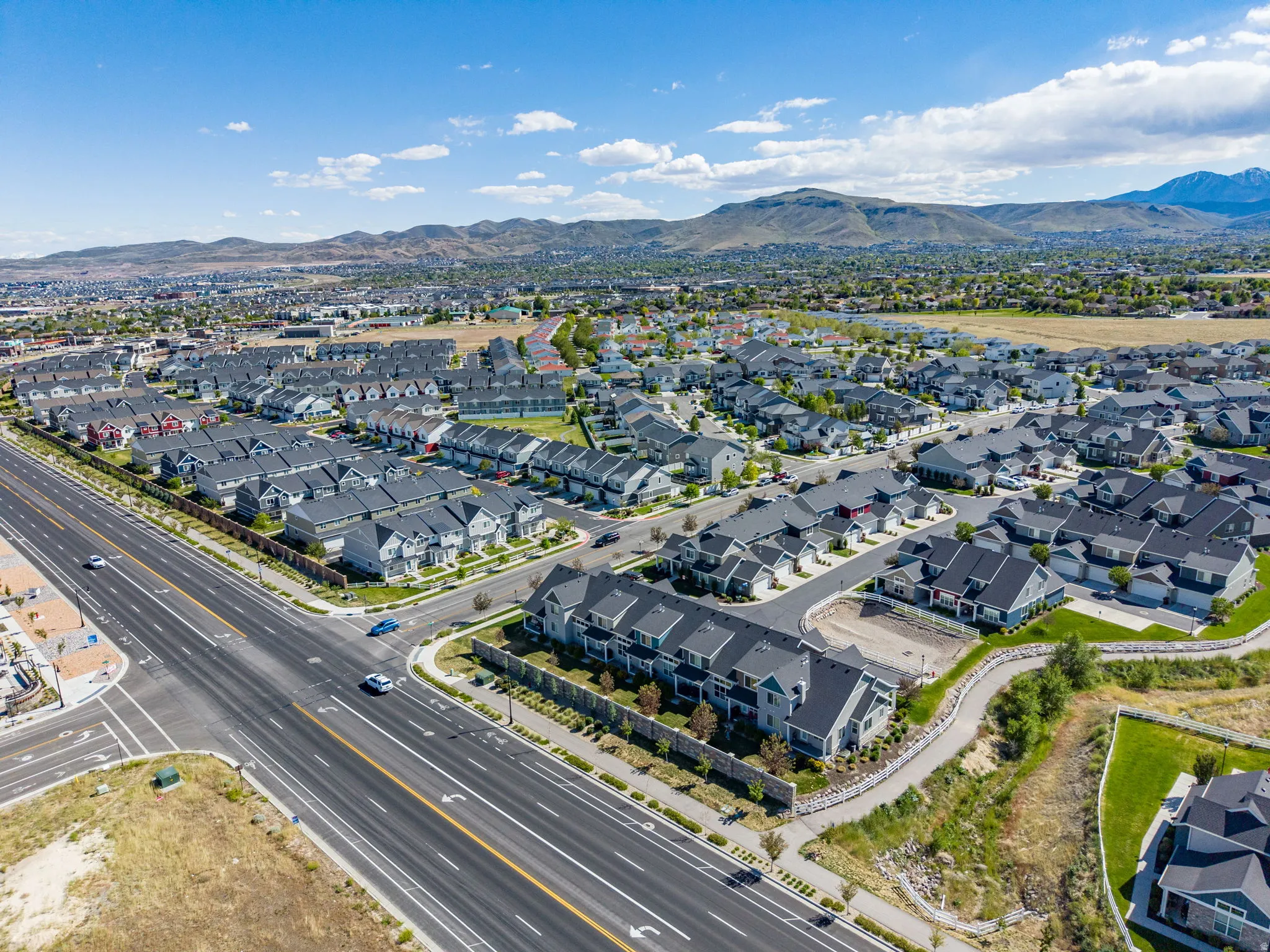 Expansive residential development featuring numerous single-family homes and townhomes with consistent architectural styles