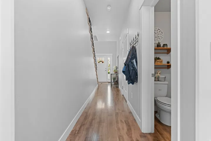 Hallway featuring wood-finish flooring
