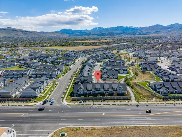 Aerial view showcasing a residential community with contemporary townhomes and single-family residences