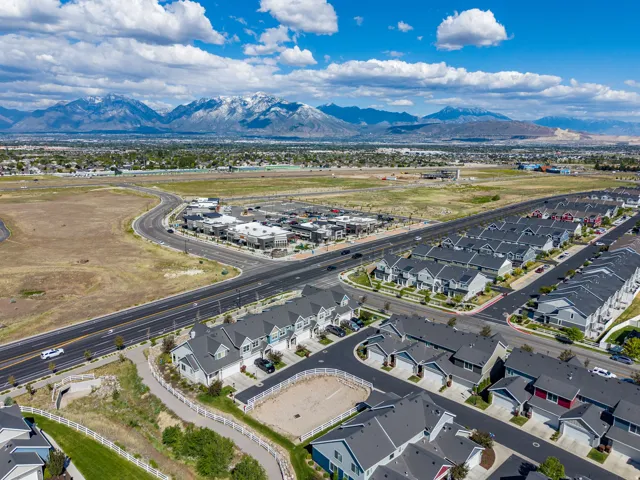 Aerial perspective showcasing a residential development with a mountain backdrop