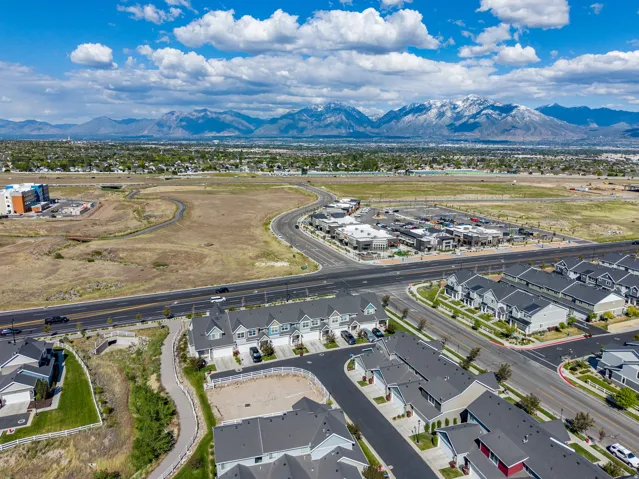 Aerial perspective showcasing a residential area with townhomes and commercial structures