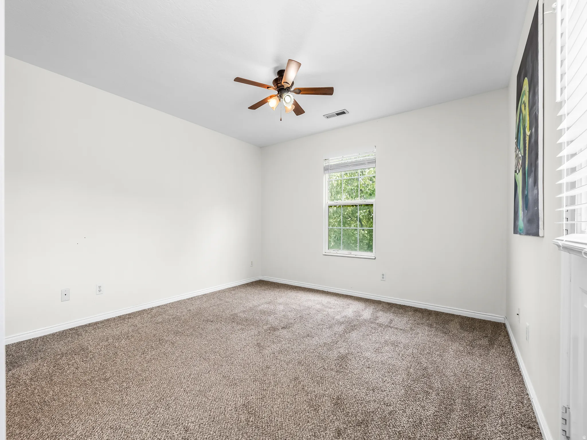 Master Bedroom Carpeted room featuring a ceiling fan with integrated lighting, a single window with blinds, and white baseboards