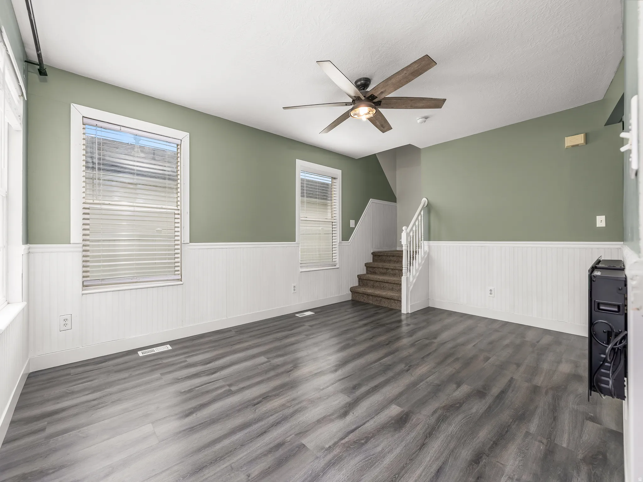 Front entrance, white beadboard wainscoting, and a ceiling fan