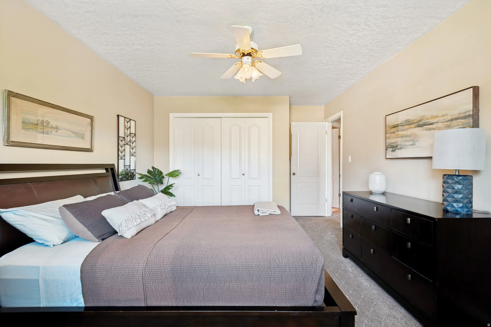 Bedroom featuring light neutral wall paint and textured ceiling