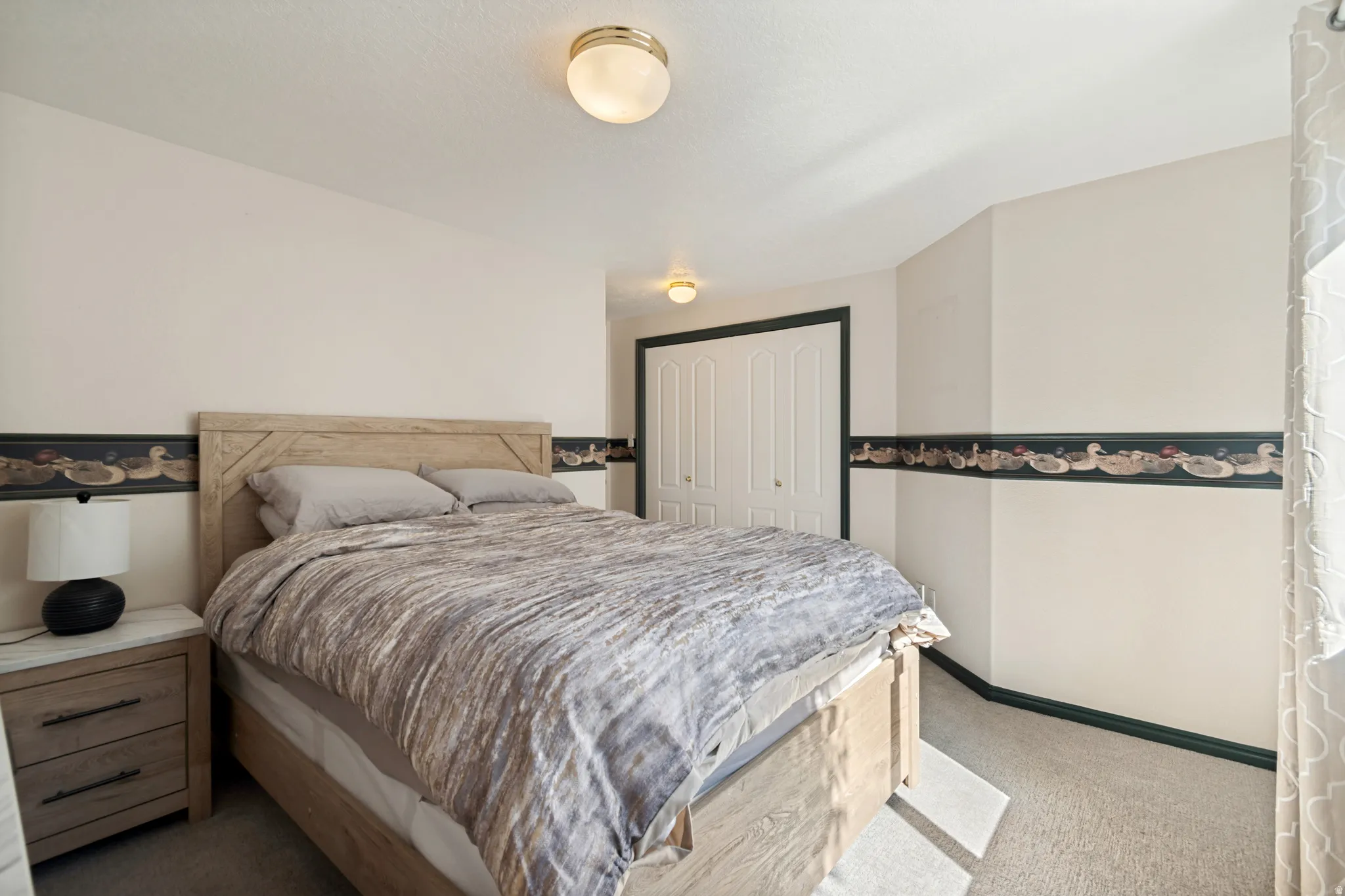 Bedroom featuring light-colored walls and carpeted flooring