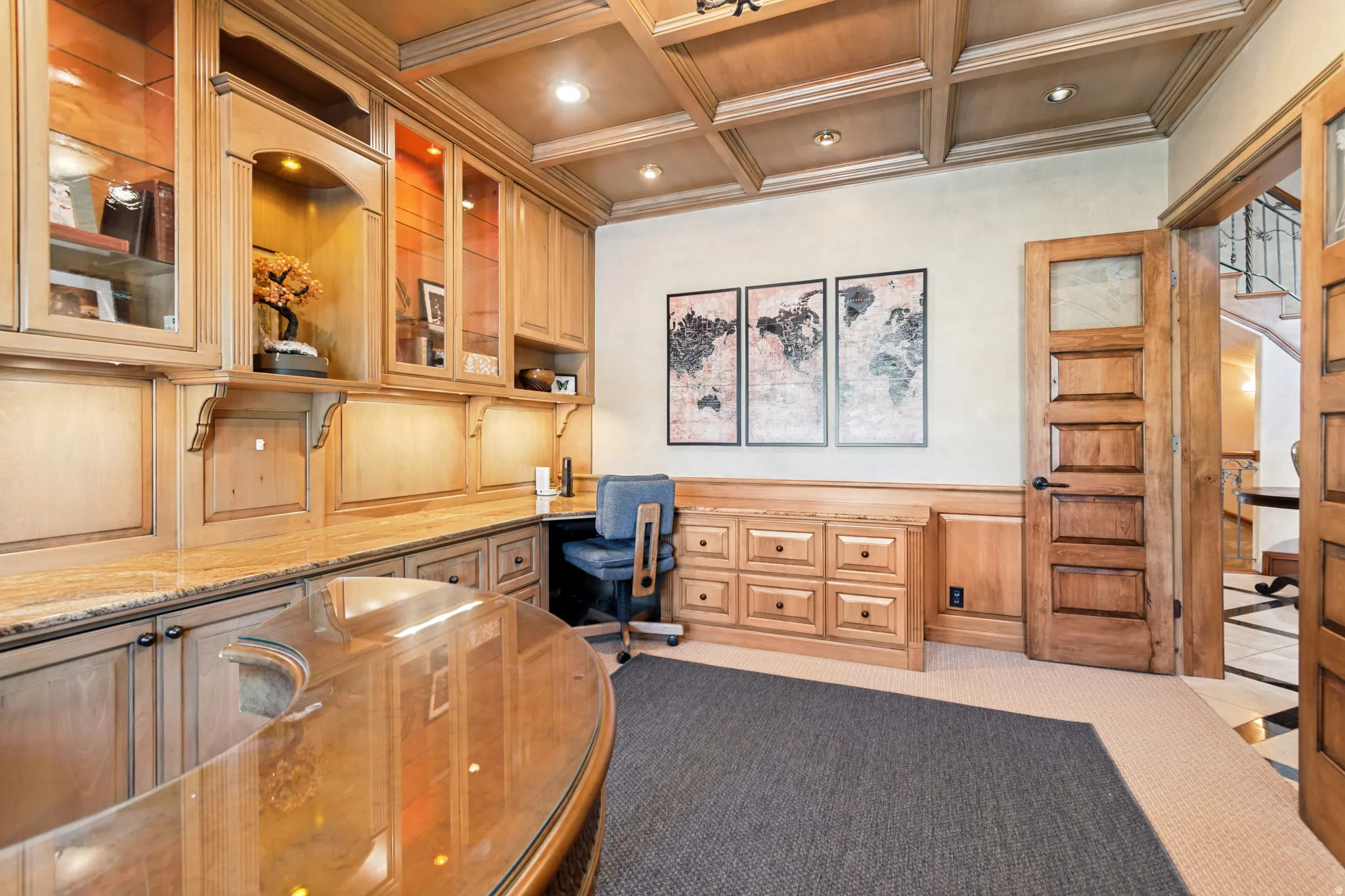 Built-in light wood cabinetry with glass-front uppers and ample counter space