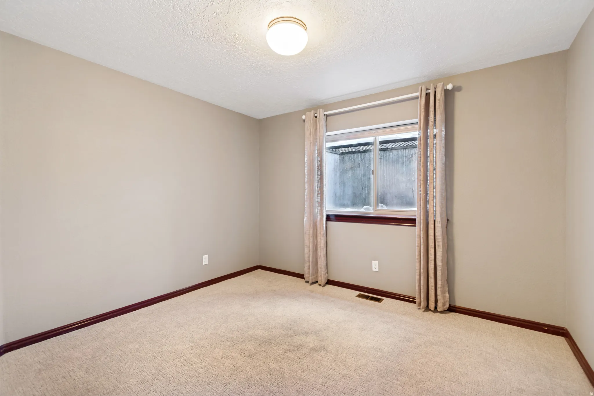 Neutral-toned walls complement a light-colored carpet