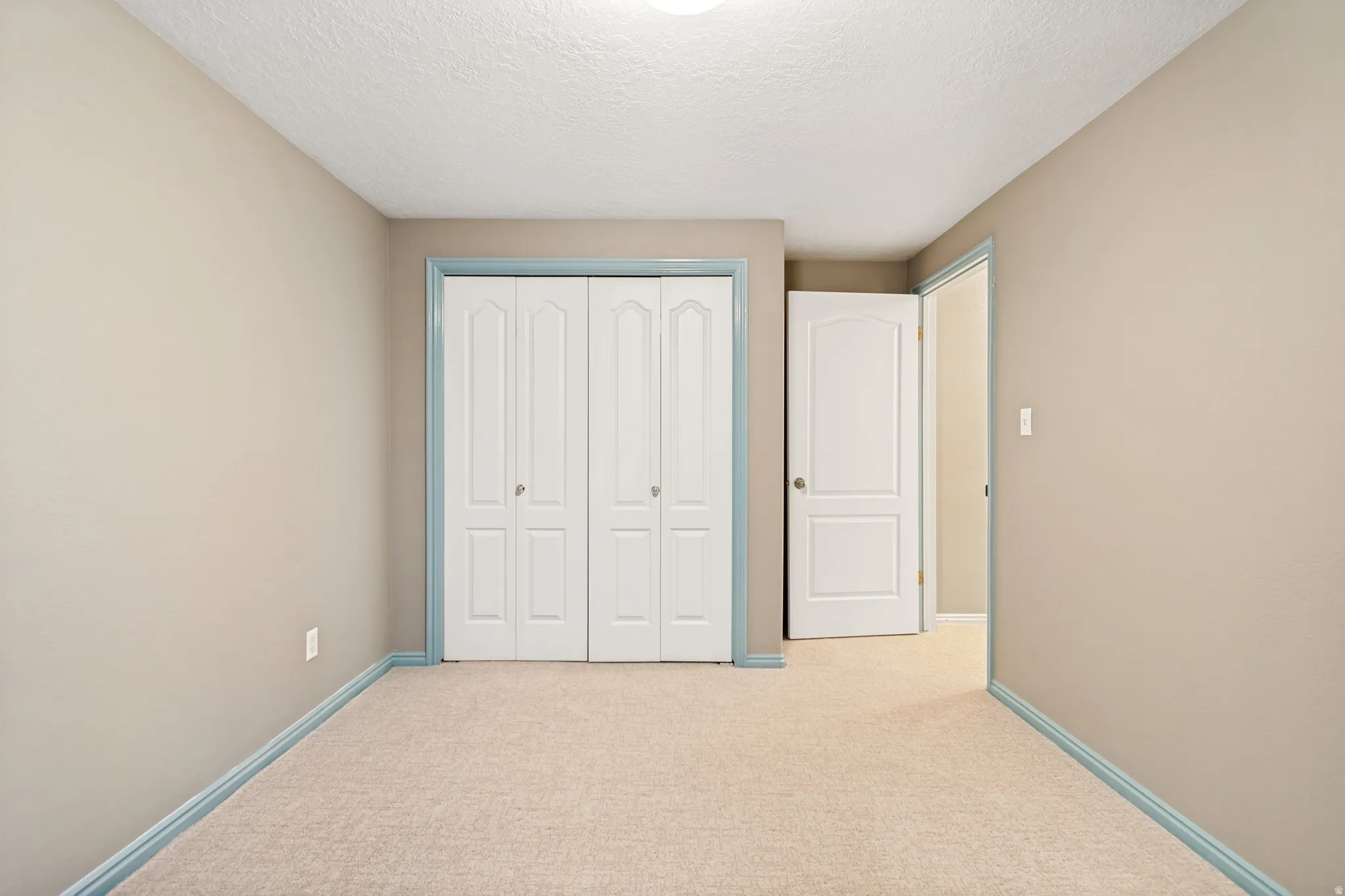 Neutral-toned walls and light-colored carpeting