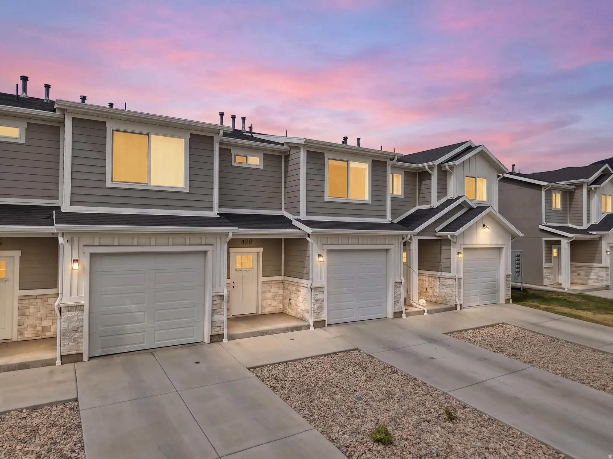 Townhome exterior featuring horizontal siding and white trim accents