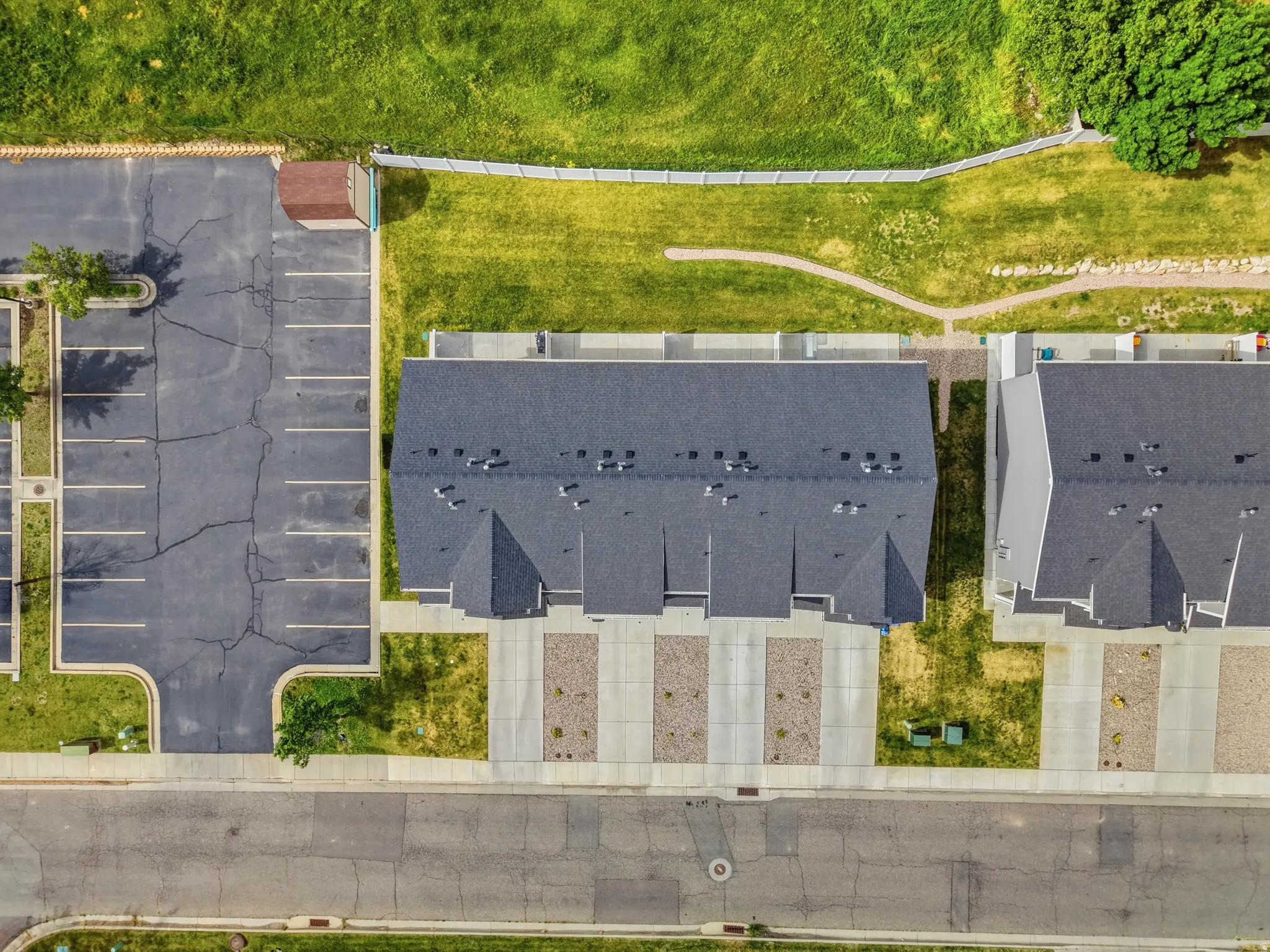 Aerial perspective showcasing new construction townhomes with dark shingle roofing