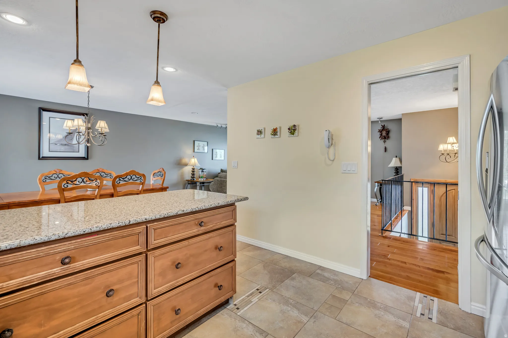 Kitchen island featuring a granite-style countertop and wood-finish cabinetry