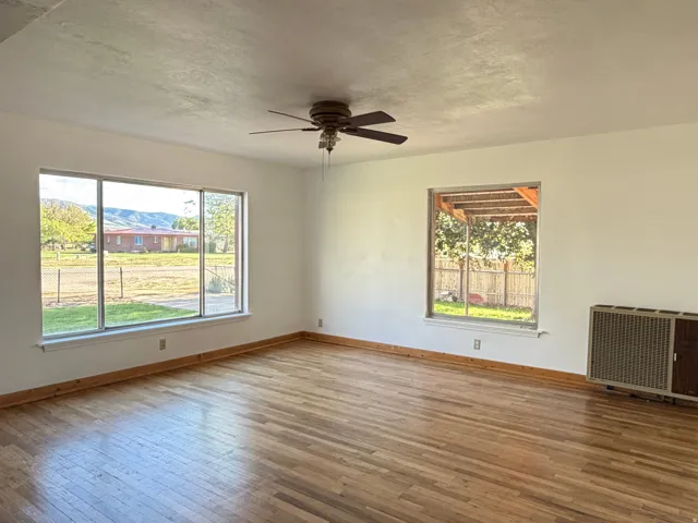 Large living room with hardwood floors and gas radiant heater