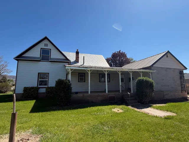 Back of house with a covered patio