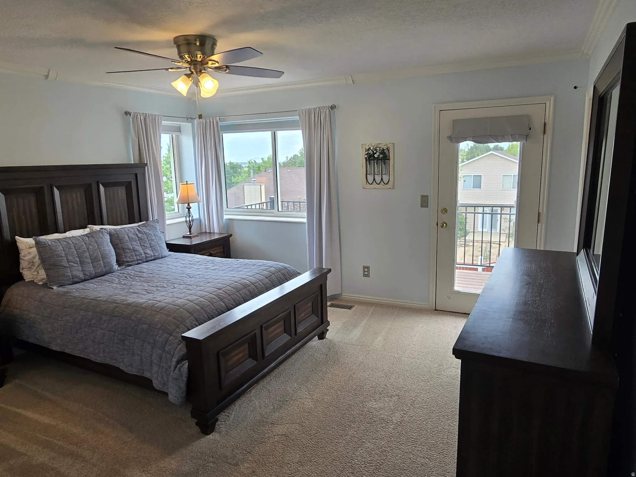 Carpeted bedroom with deck