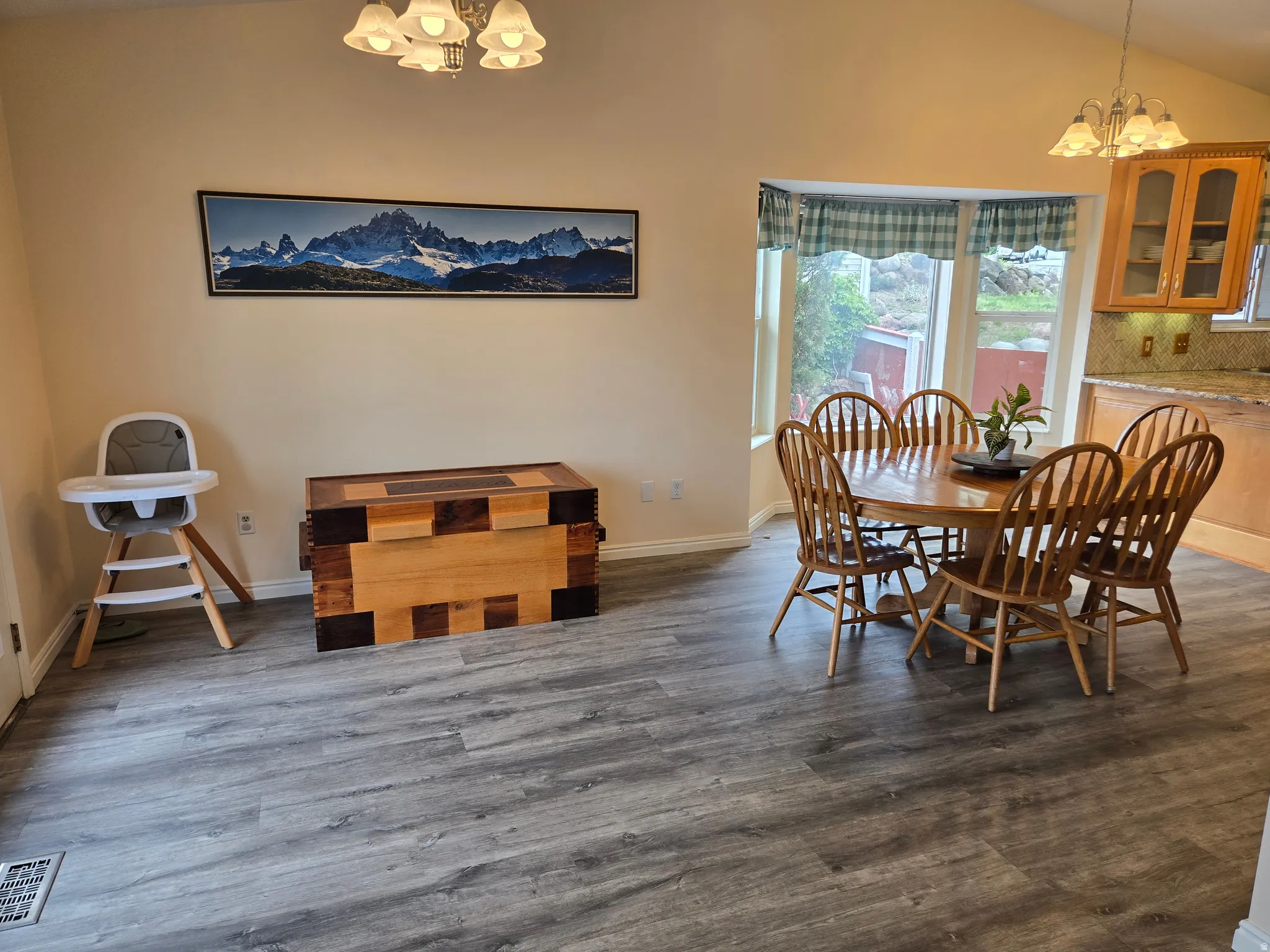 Spacious dining area featuring a bay window, and vaulted ceilings