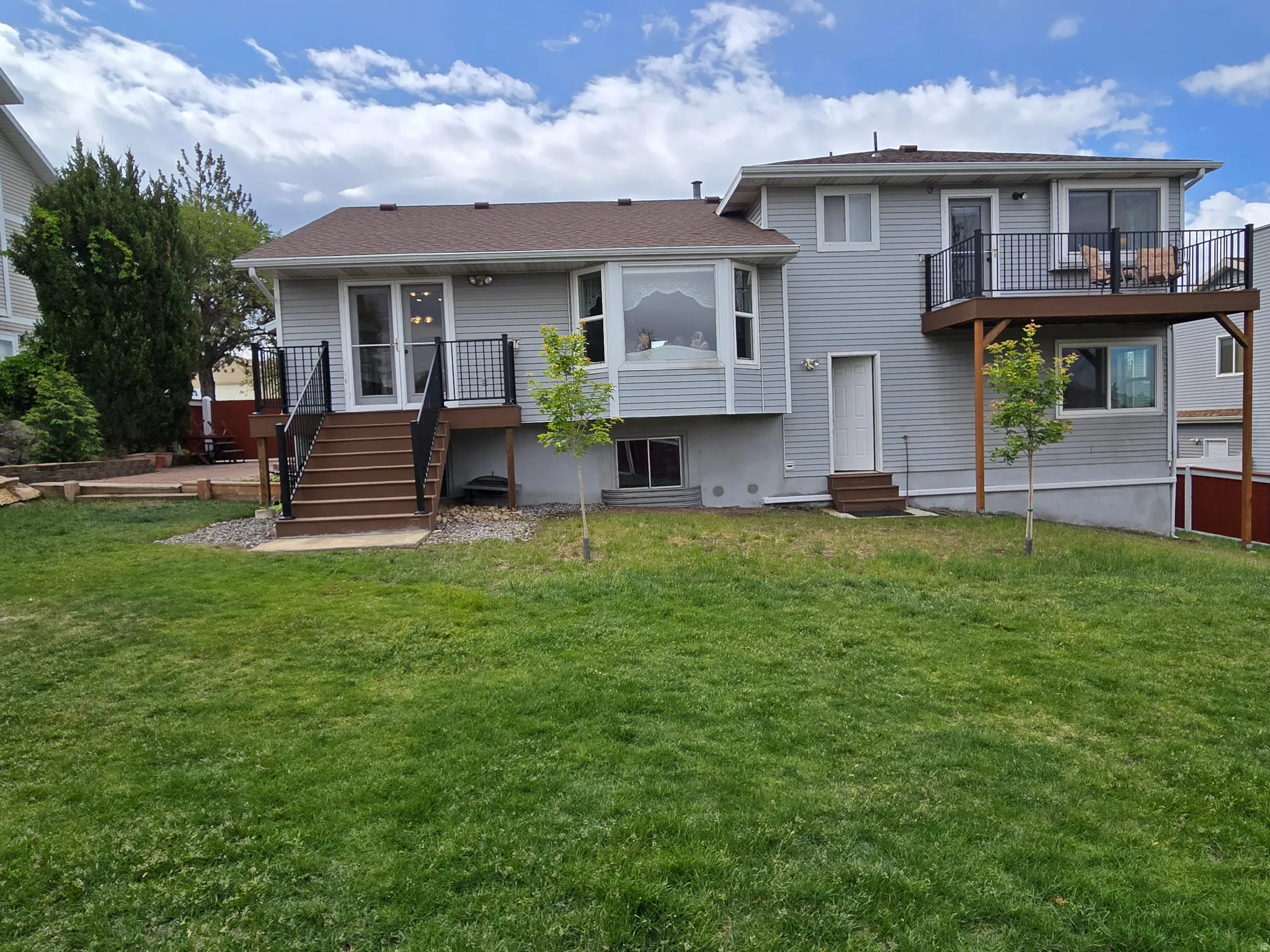 Expansive rear yard featuring a large green lawn