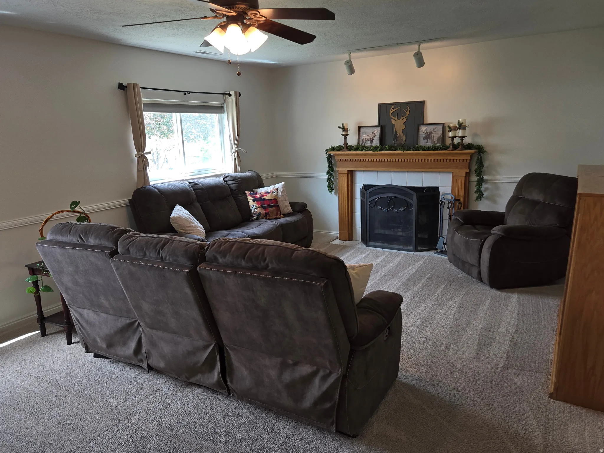 Carpeted living area featuring a fireplace