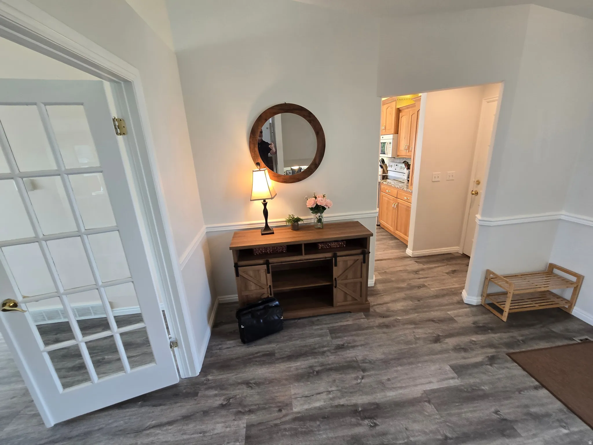 Entryway featuring wainscoting, and a French door