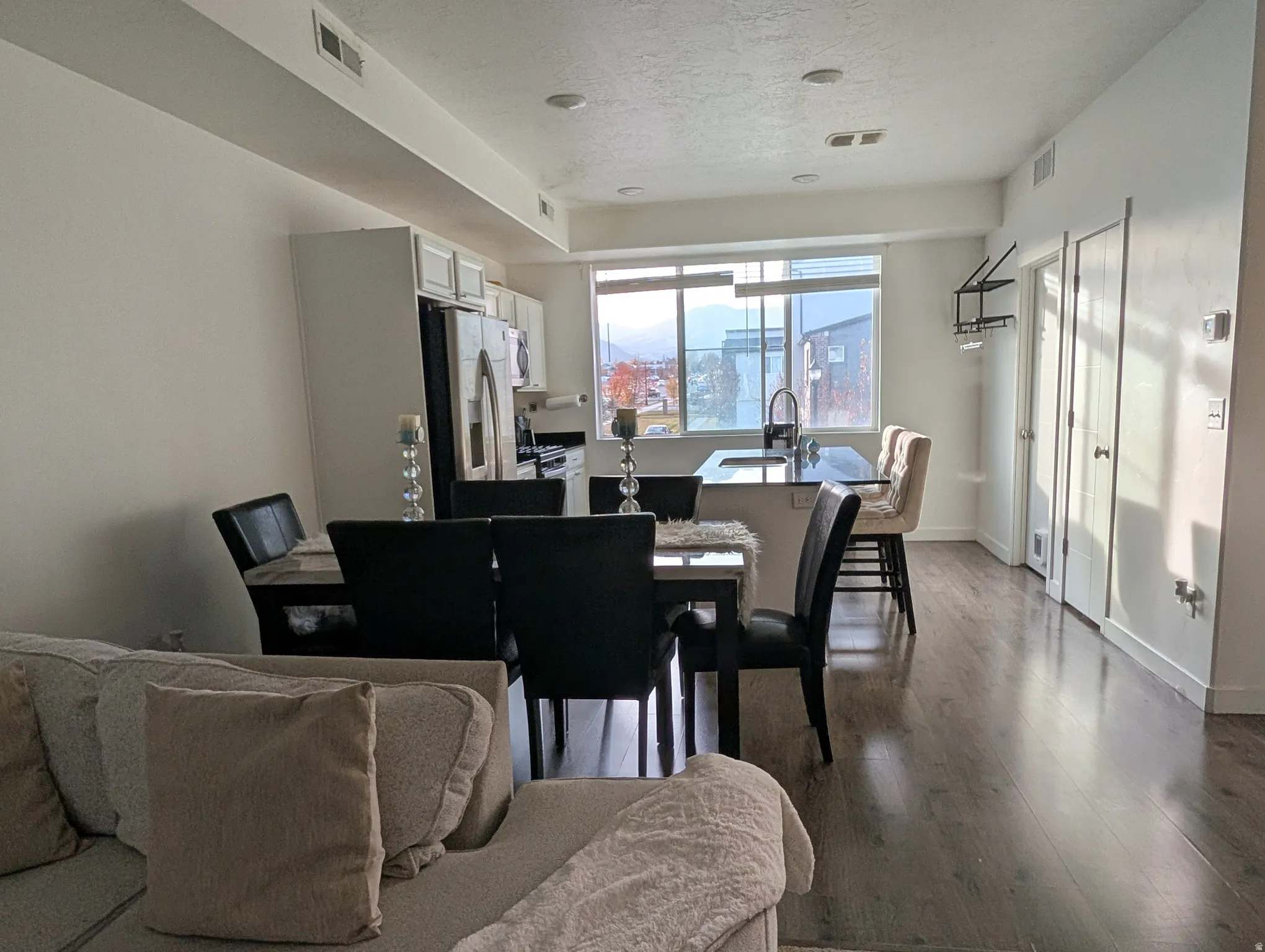 Open-concept living space featuring wood-finish flooring and recessed lighting