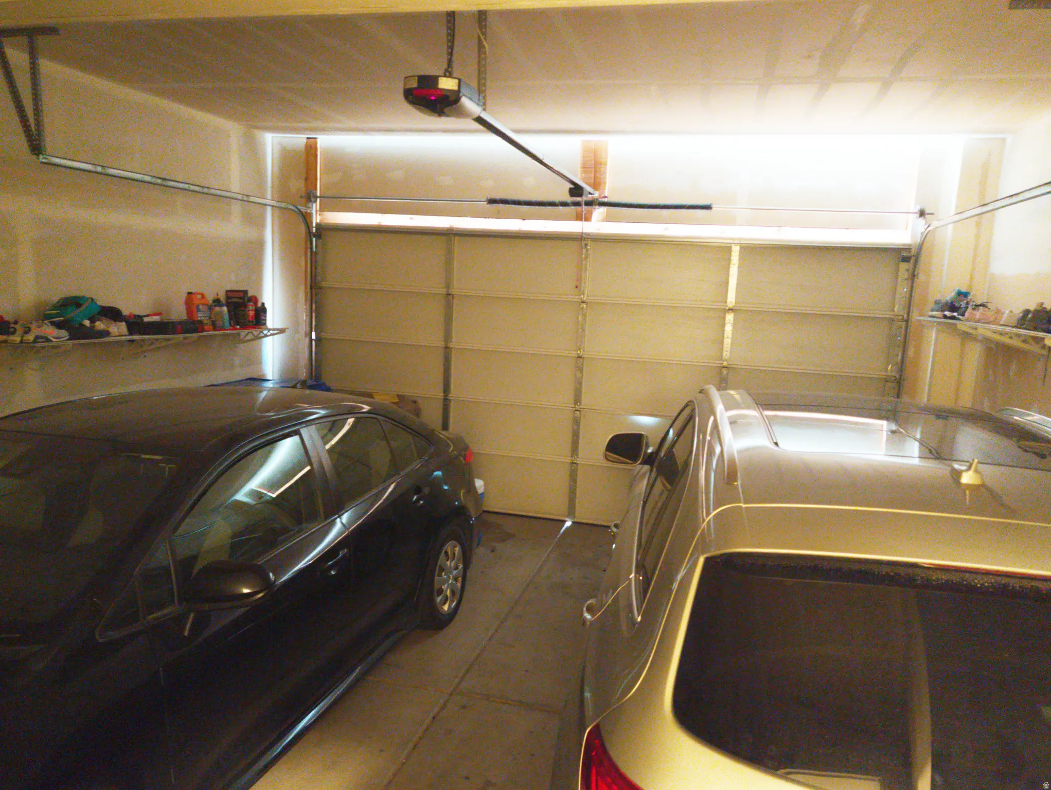 Attached garage with a sectional overhead door and automatic opener