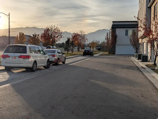 Paved driveway and street with mountain backdrop