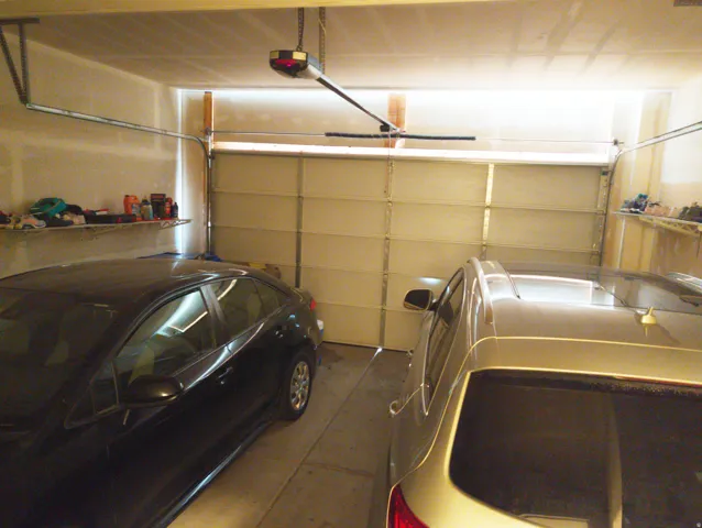 Attached garage with a sectional overhead door and automatic opener
