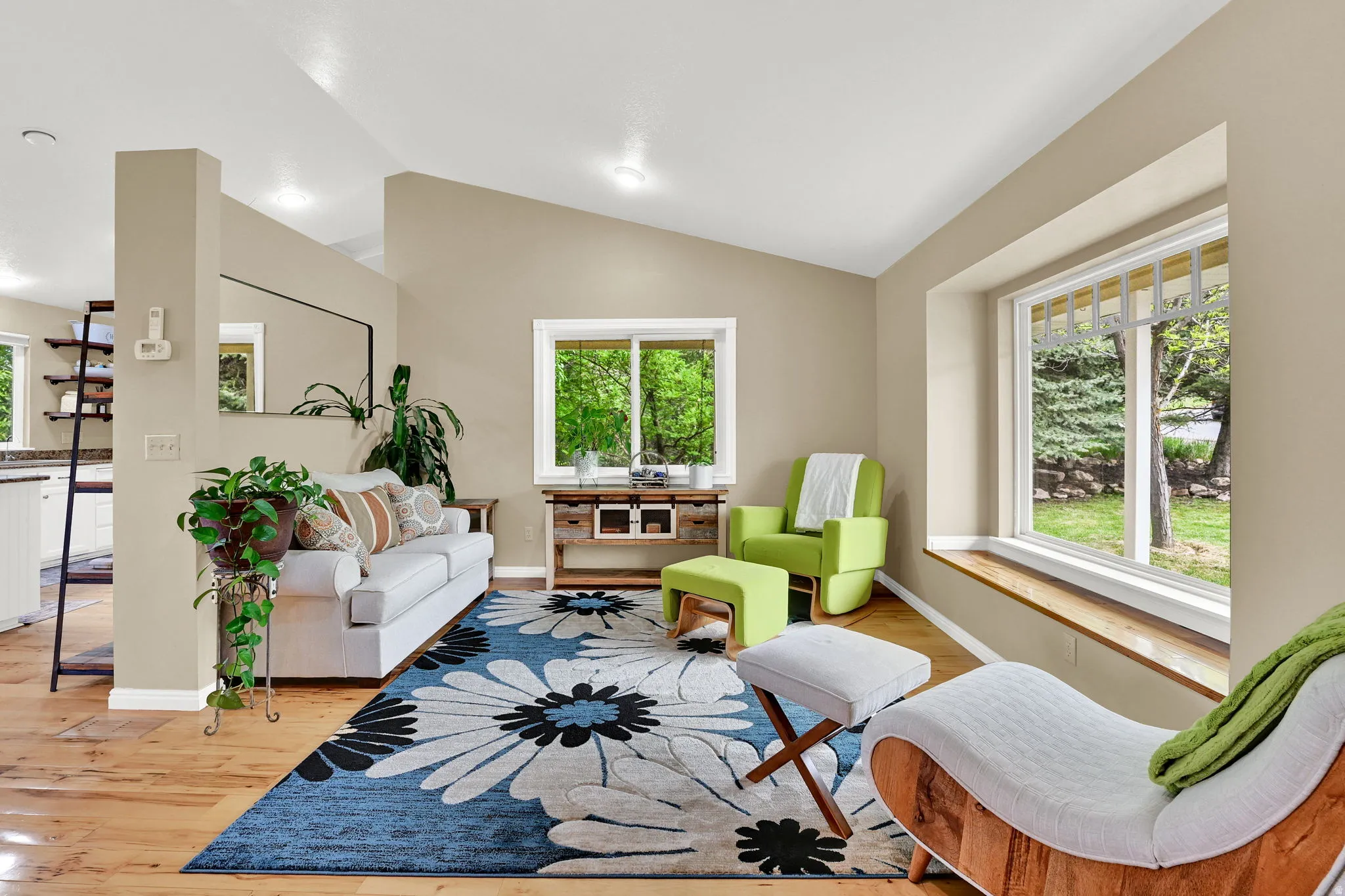 Living area featuring wood-finish flooring, recessed lighting, and a vaulted ceiling