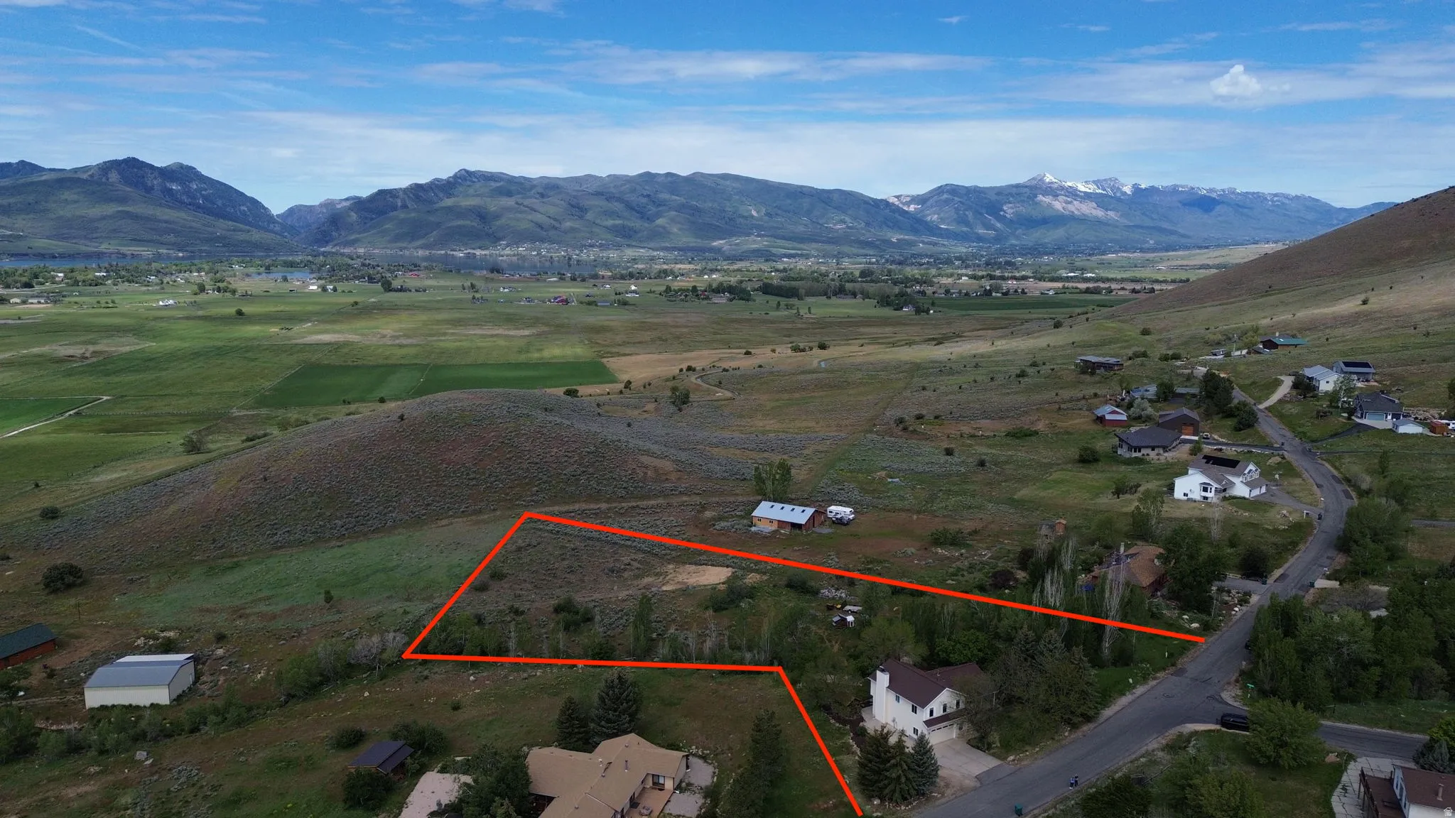 Expansive vacant lot featuring a natural, undeveloped landscape with mature trees