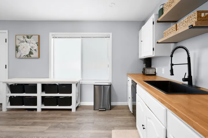 Modern kitchen or utility space featuring wood-finish flooring