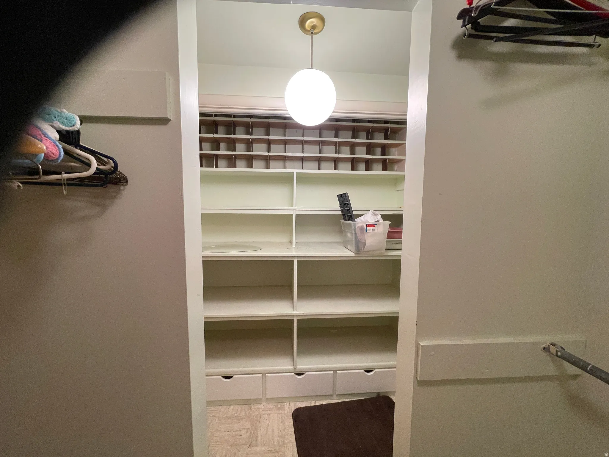 Built-in closet system featuring multiple shelving units, integrated drawers, and upper cubby storage round out the walk-in pantry Features