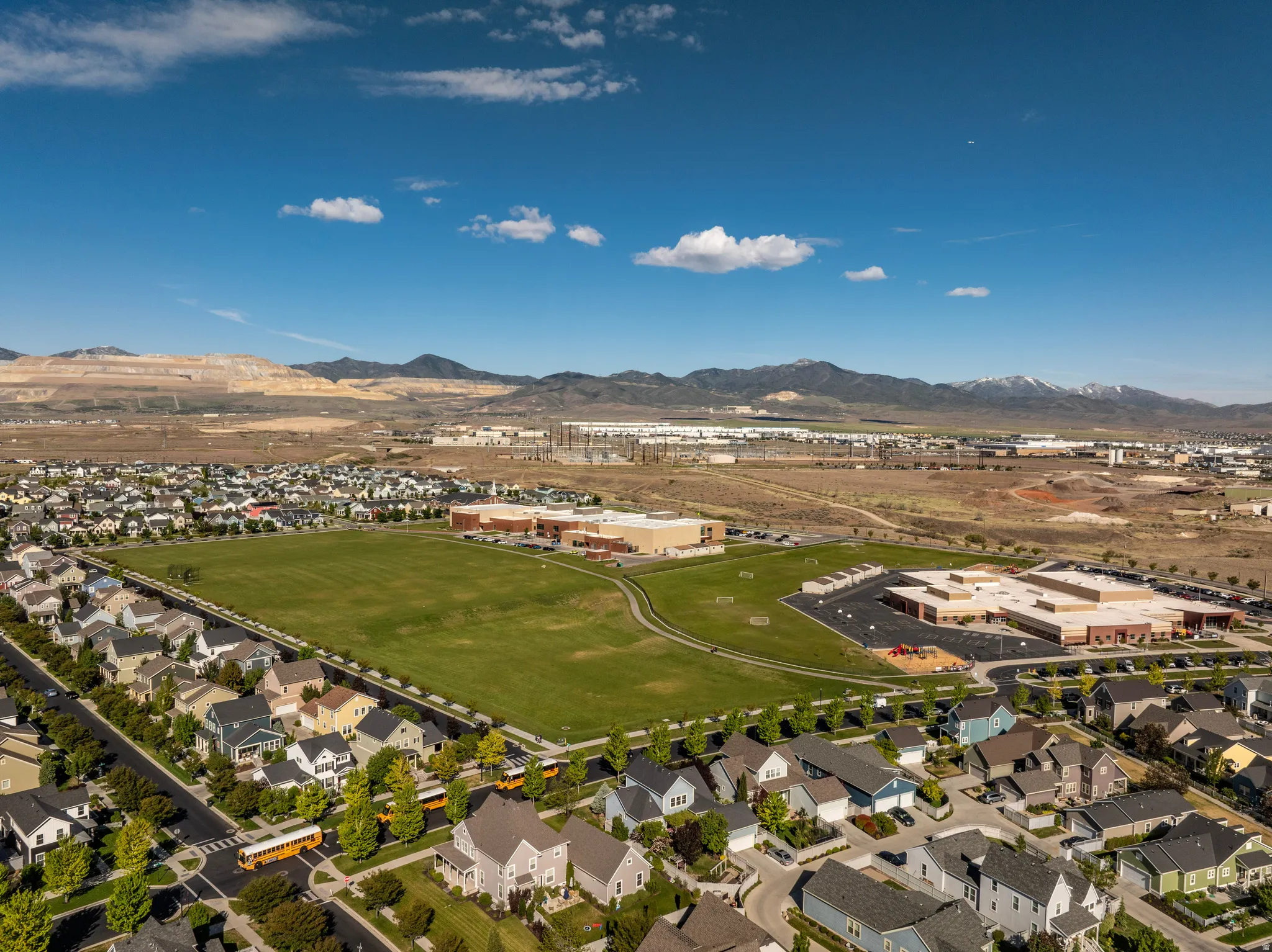 Expansive residential development featuring numerous single-family homes, mature street trees, and well-maintained roadways