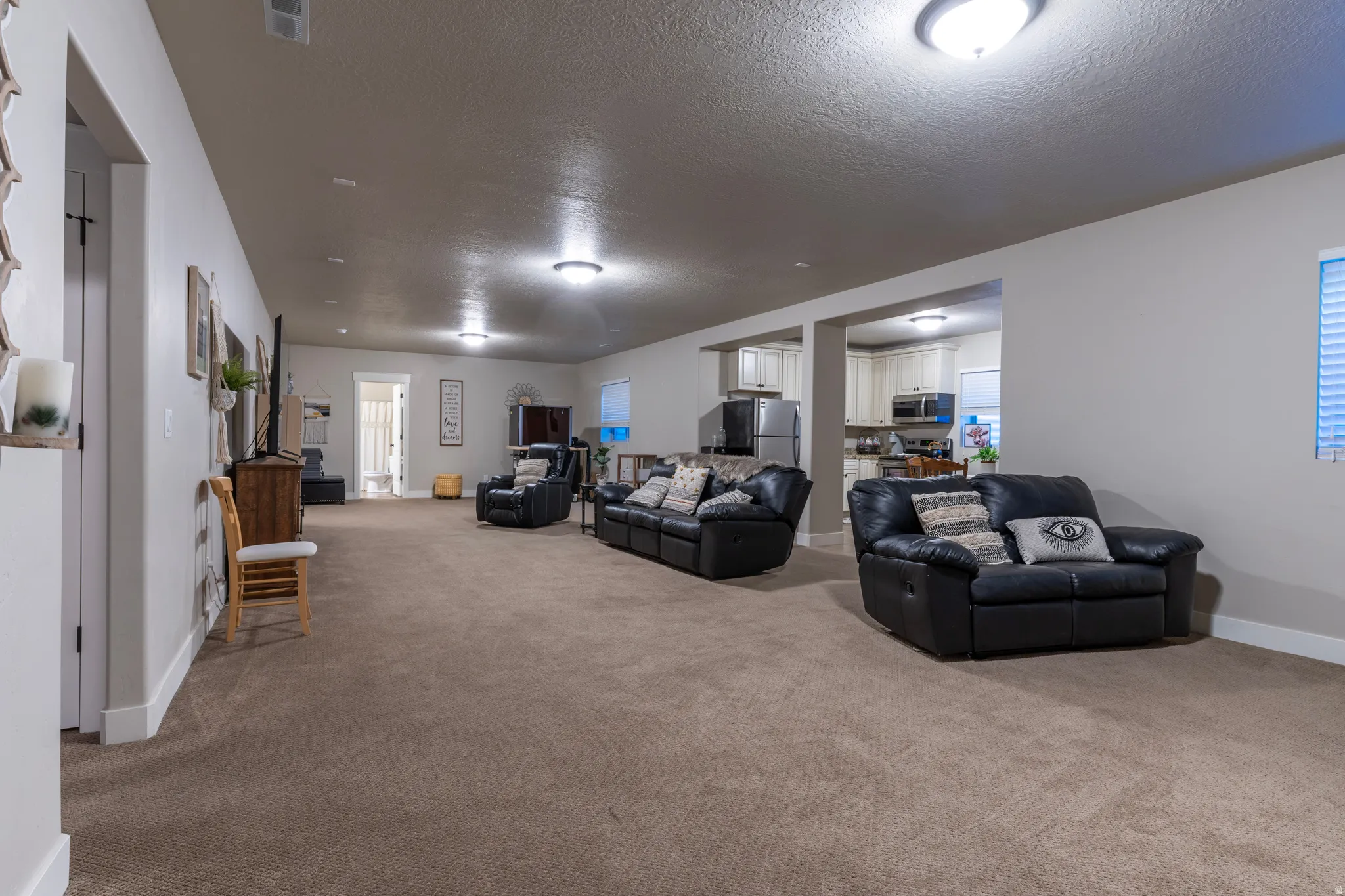 Spacious carpeted room featuring recessed lighting and a neutral wall palette