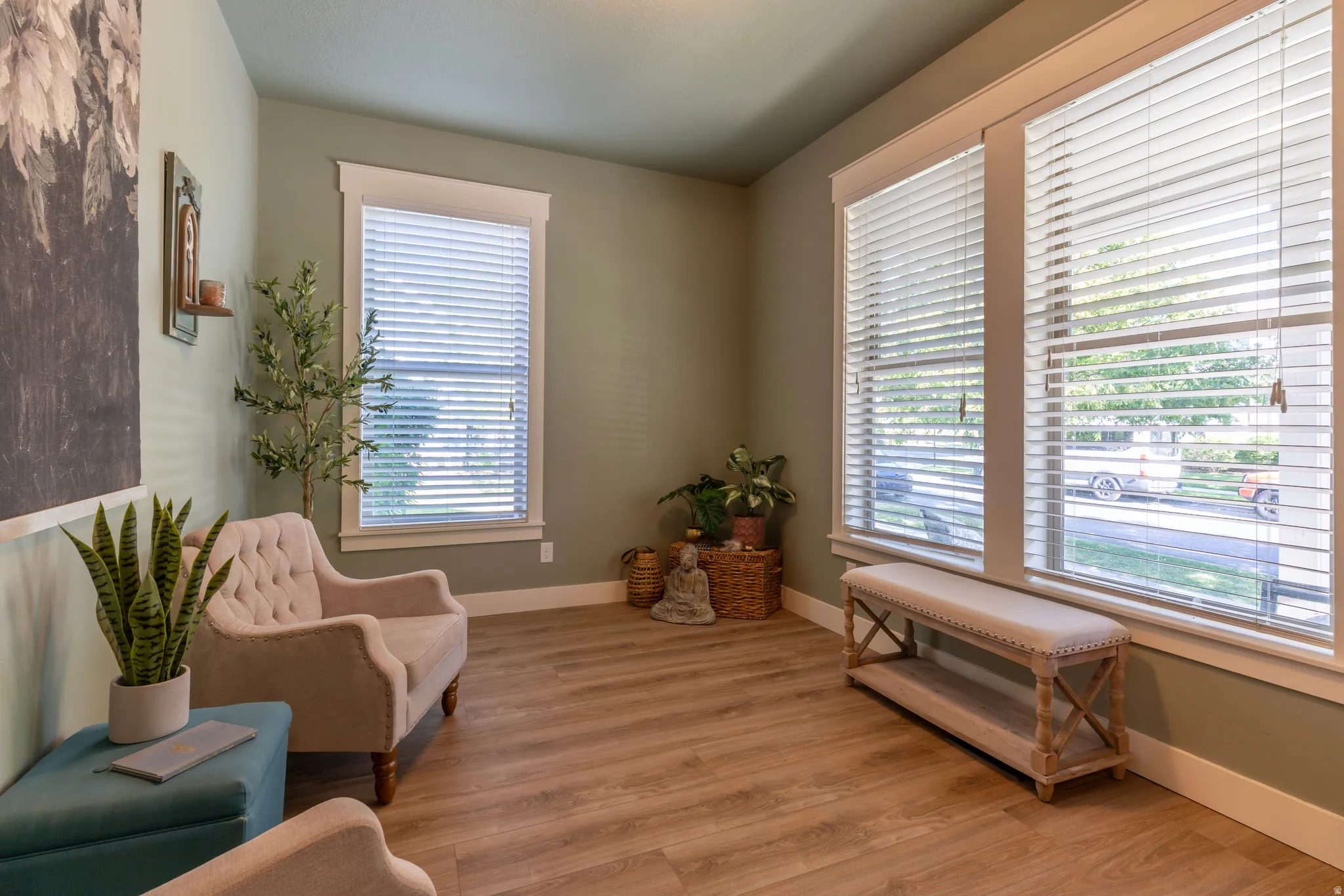 Light wood-finish flooring complements soft green walls