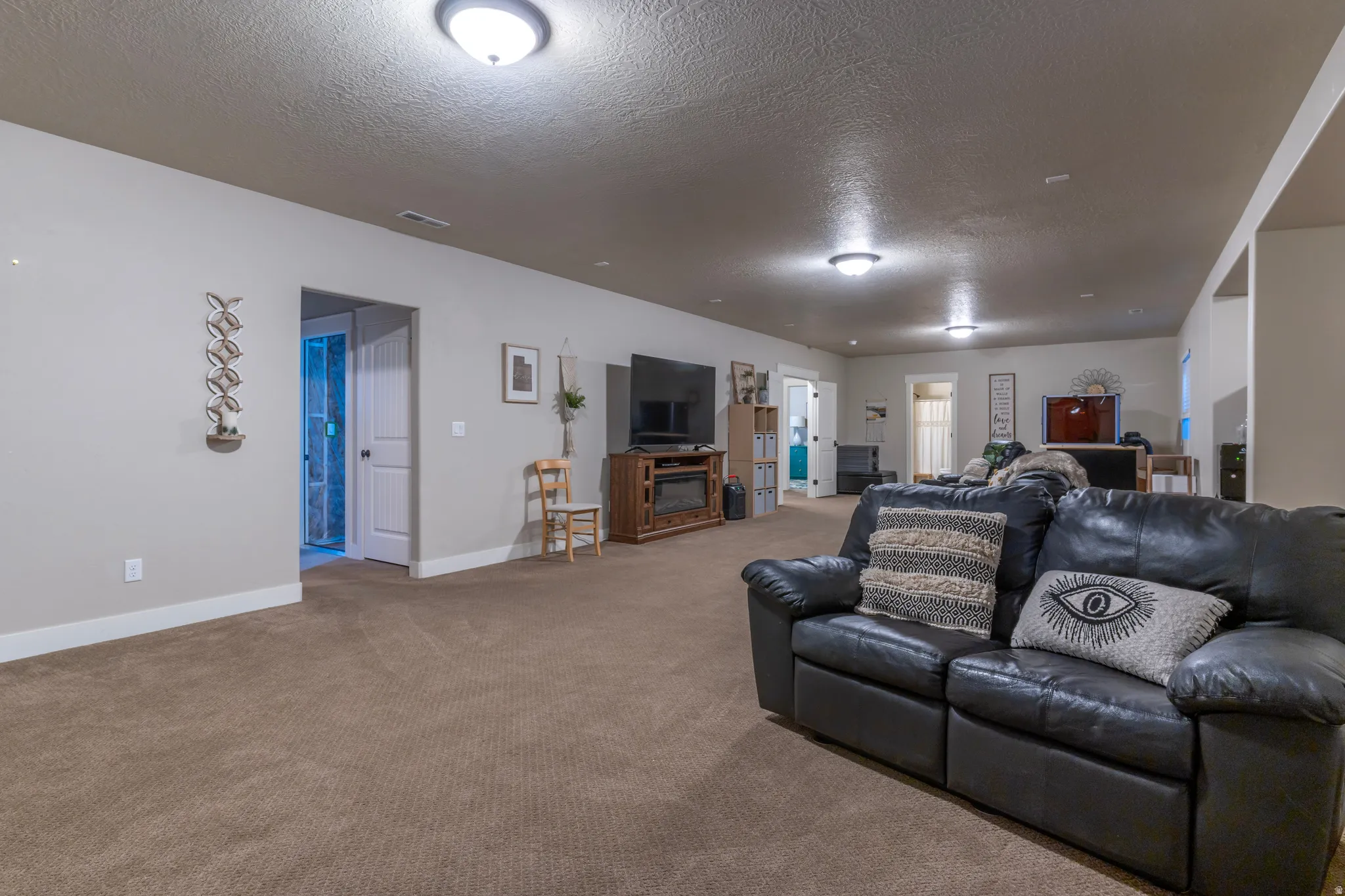 Spacious carpeted room featuring recessed lighting and neutral wall tones
