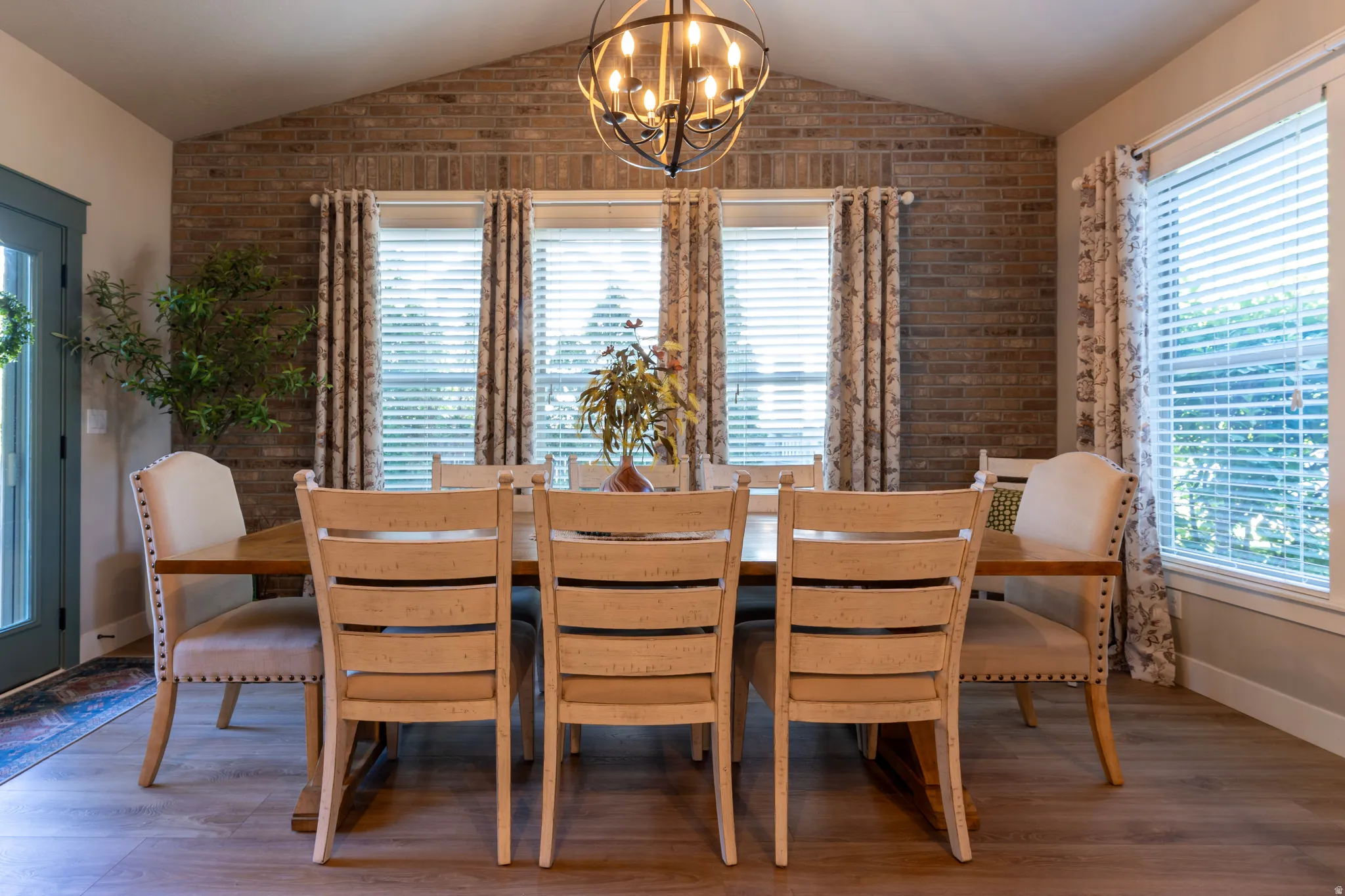Vaulted ceiling with brick accent wall and exposed beam