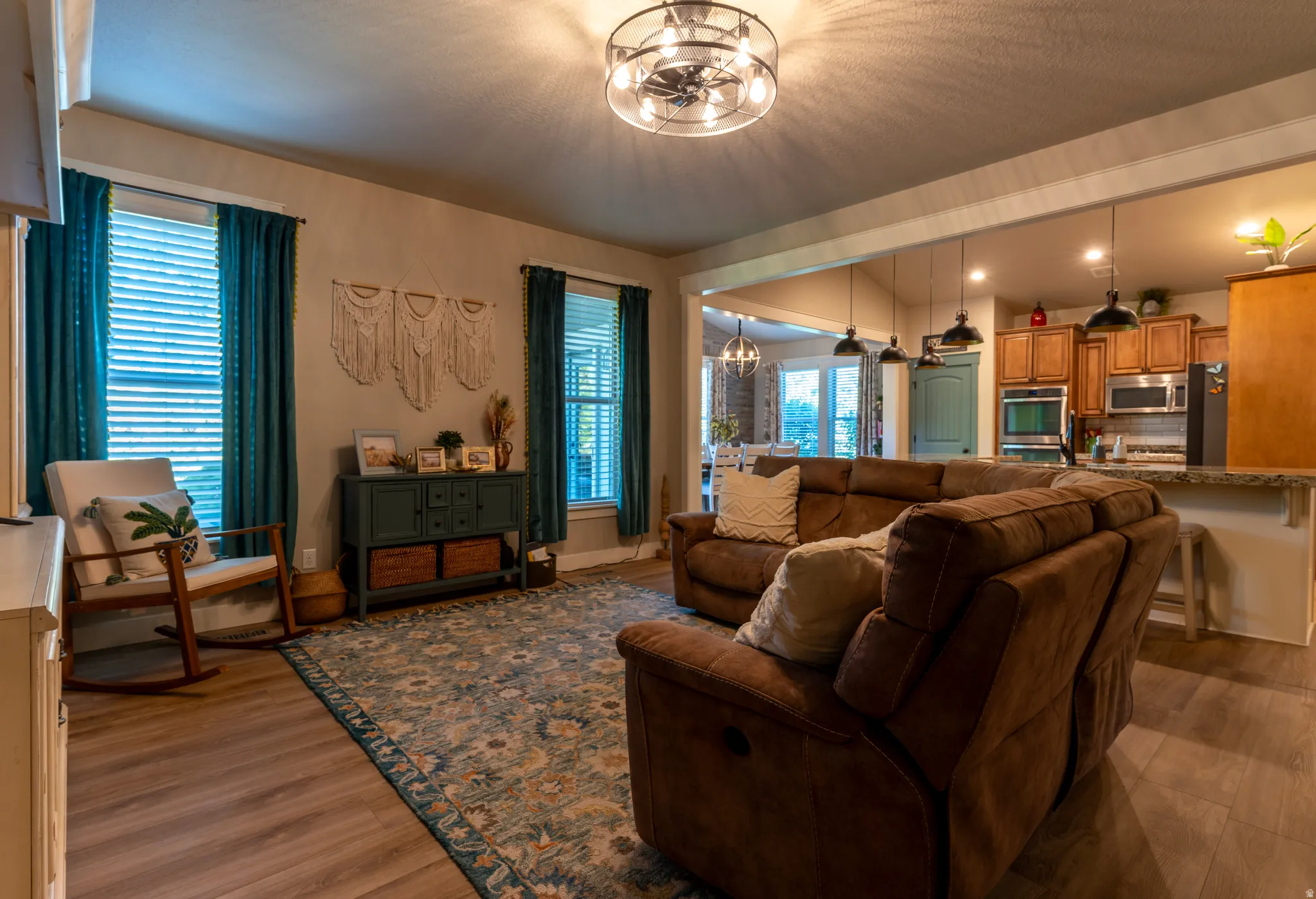 Open-concept living space featuring wood-finish flooring and a contemporary ceiling fan