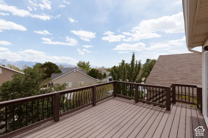 Expansive outdoor deck featuring composite decking and decorative wrought iron-style railings