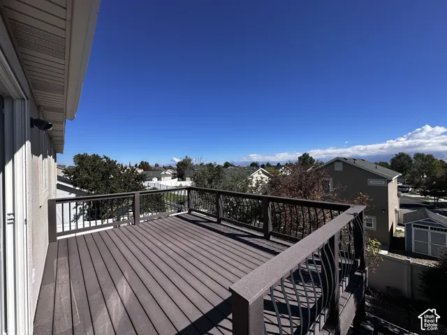 Expansive outdoor deck featuring composite decking and a wrought iron railing