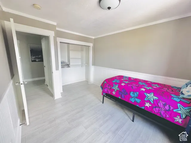 Light wood-finish flooring extending throughout the room