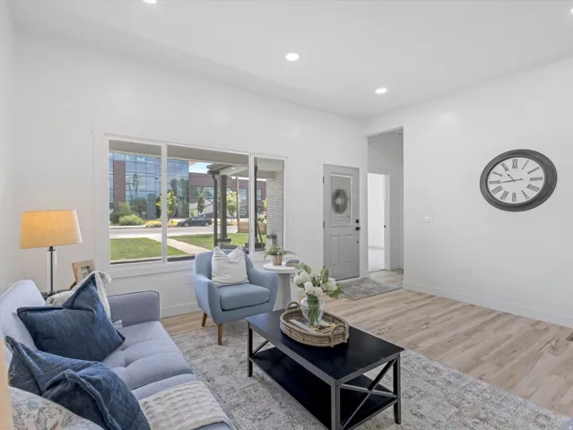 Bright living area featuring wood-finish flooring and recessed lighting