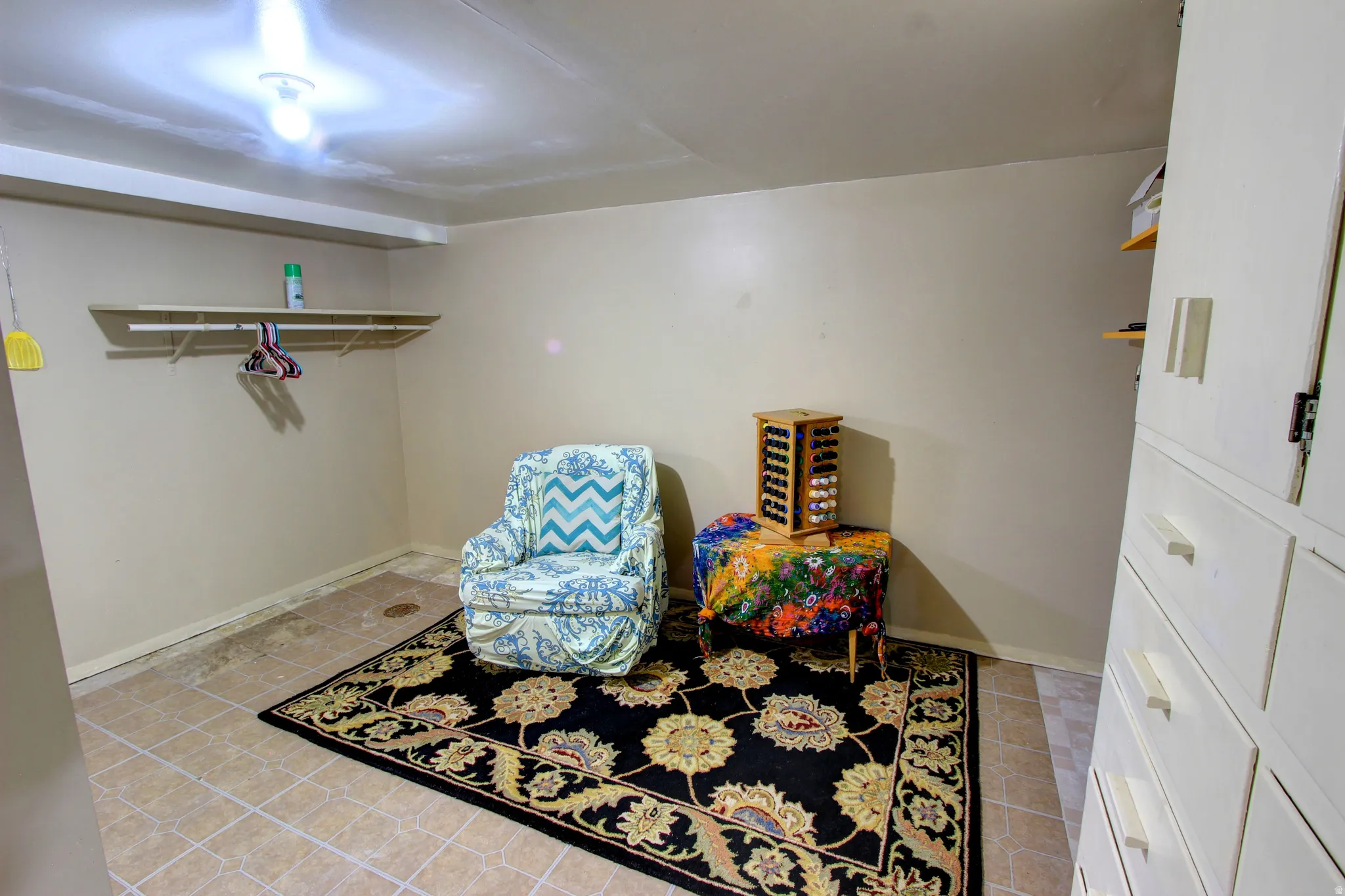 Utility room with tile flooring, built-in shelving, and integrated overhead lighting