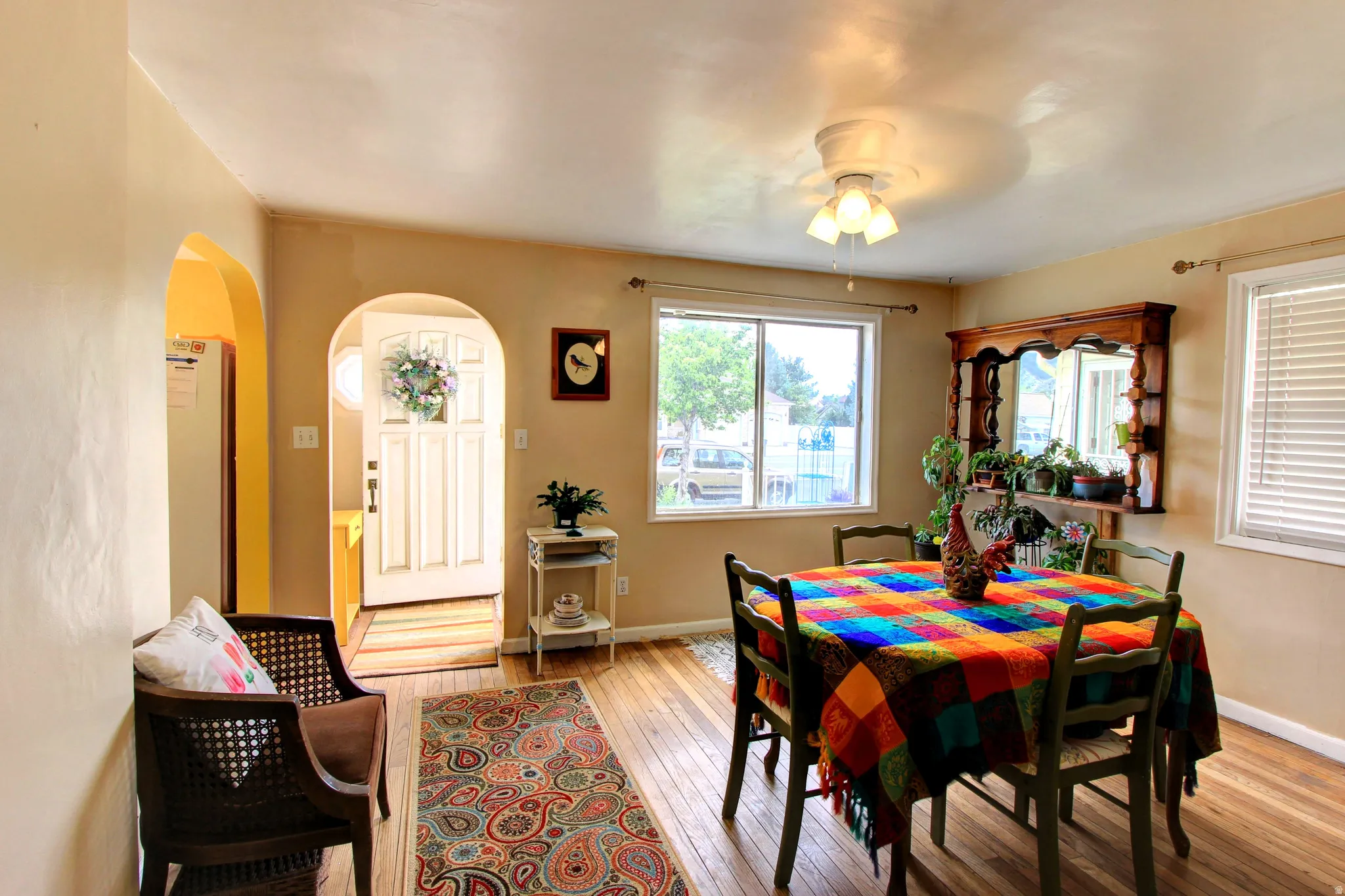 Interior room with wood-finish flooring and archway entryways